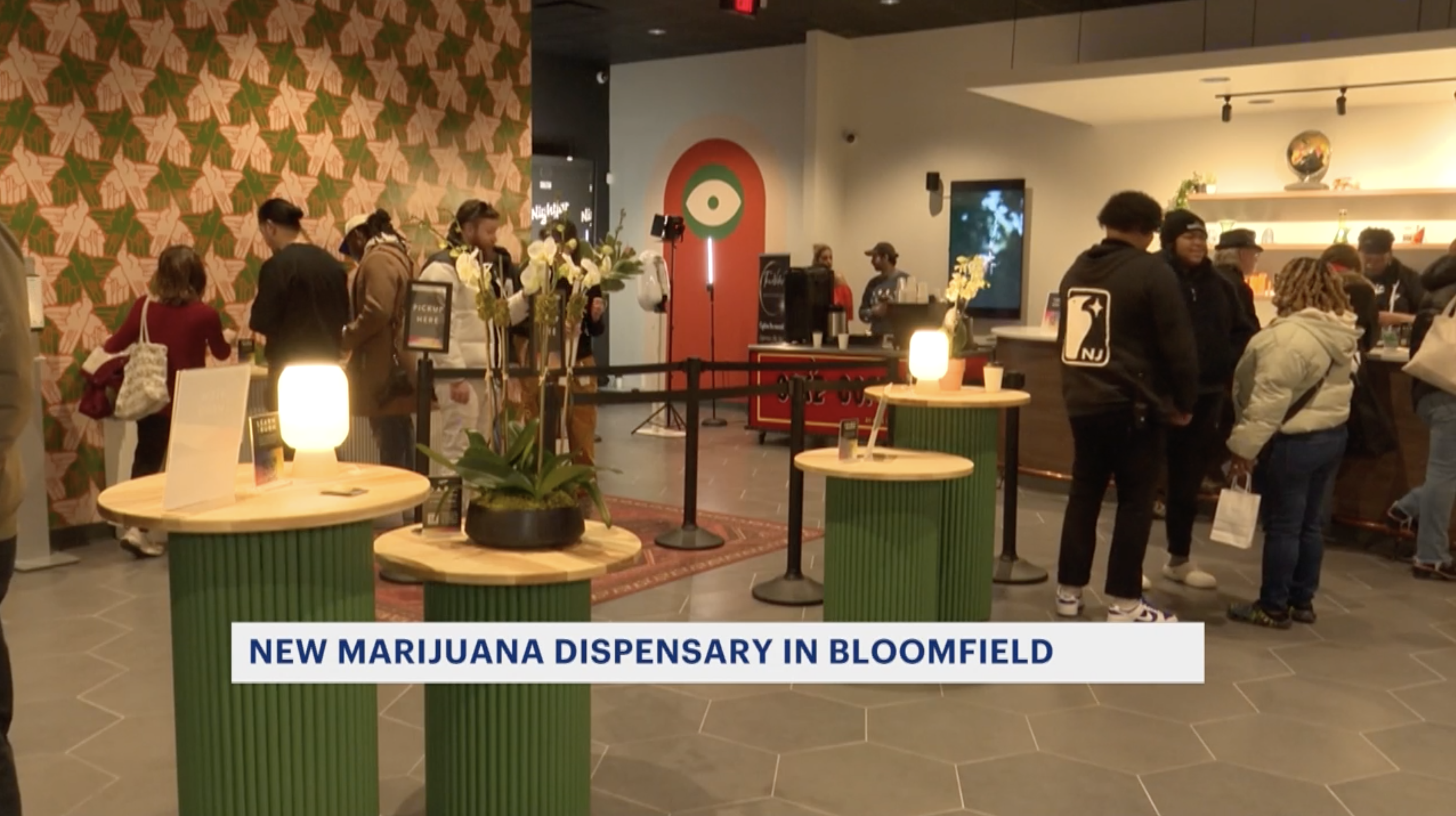 People standing in line inside a modern cannabis retail store in Bloomfield